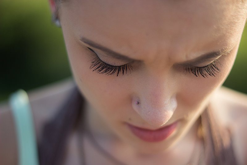 Close-up of young woman looking down | Infidelity, Betrayal, and Affair Counseling| Reconnecting Columbus