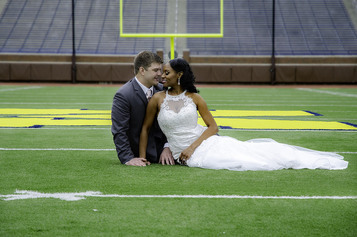 Image of multicultural wedding couple on football field | Making relationships work | Reconnecting Columbus Marriage Counseling | Ohio