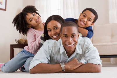 Happy Black Family, father is central with mother and young children